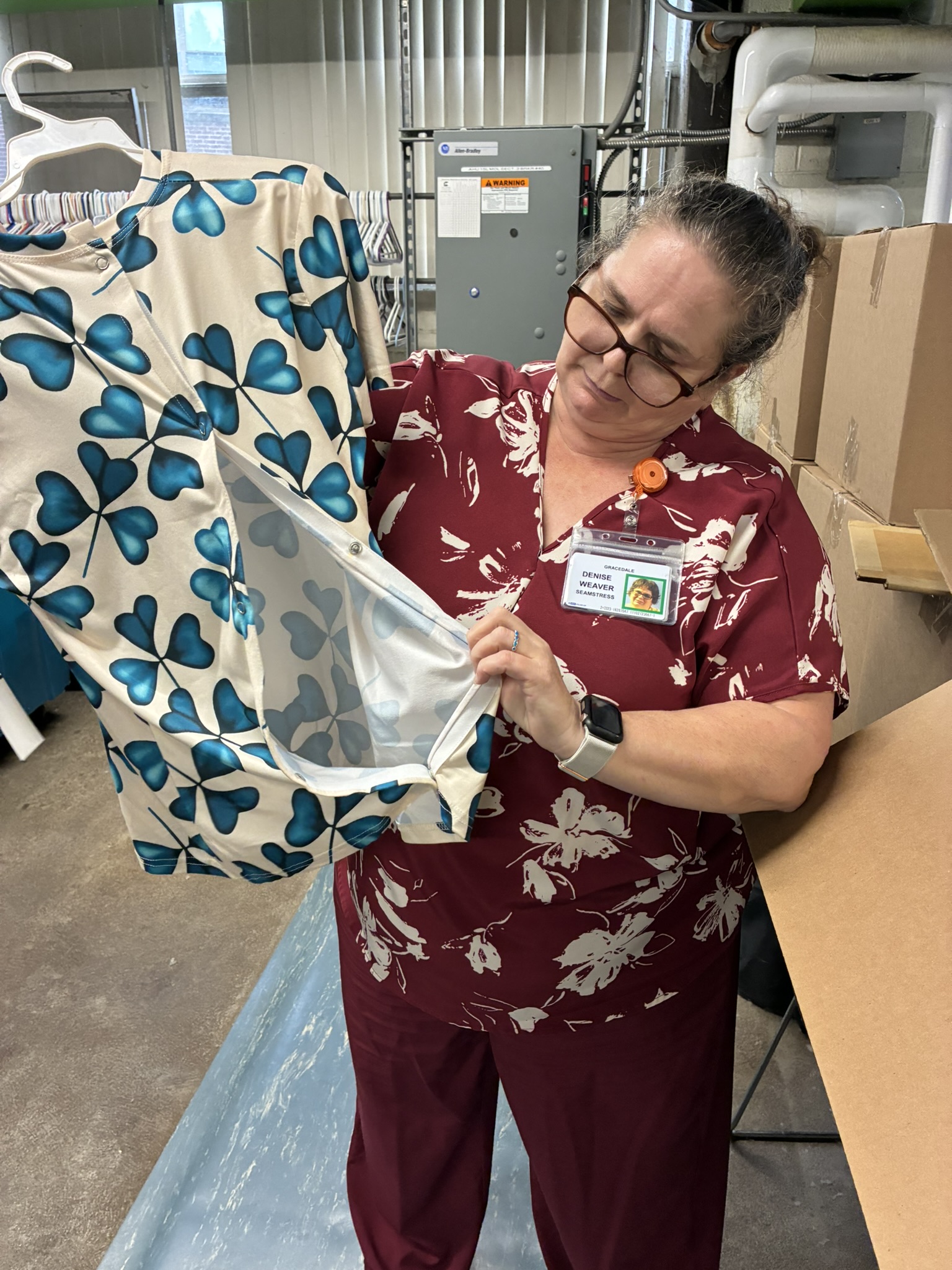 seamstress looks at shirt