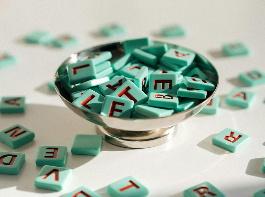 Scrabble game pieces in a bowl